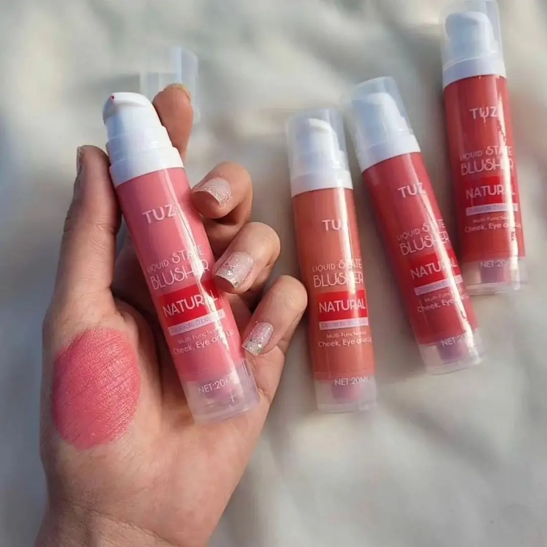 TUZ Liquid State Blusher swatched on hand with multiple blushers in background